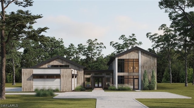 view of front of home featuring a front lawn and a garage