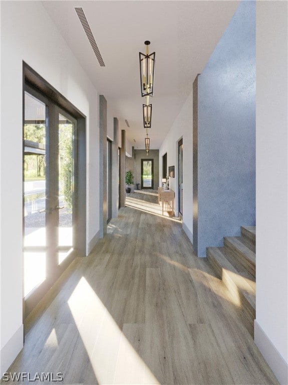 hallway featuring dark hardwood / wood-style flooring and an inviting chandelier