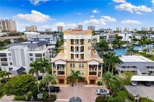 view of building exterior featuring a water view and a city view