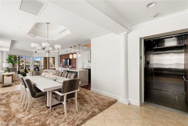 dining area with decorative columns, visible vents, elevator, a tray ceiling, and crown molding