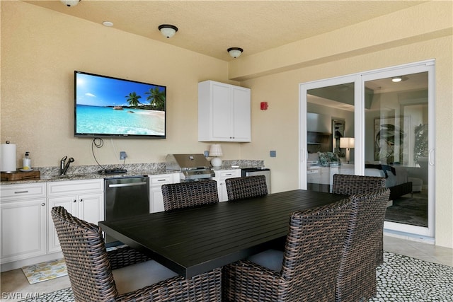 tiled dining area featuring sink