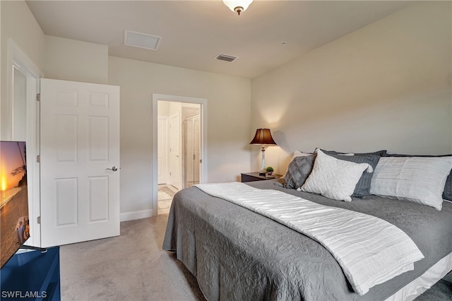 carpeted bedroom featuring ensuite bathroom