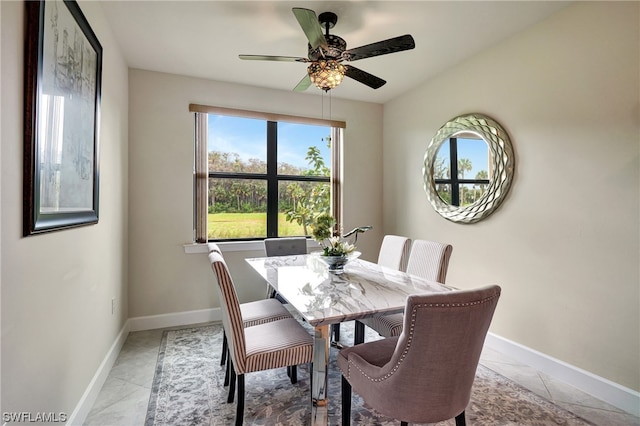 tiled dining space with ceiling fan