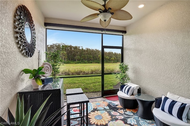 sunroom with ceiling fan and a healthy amount of sunlight