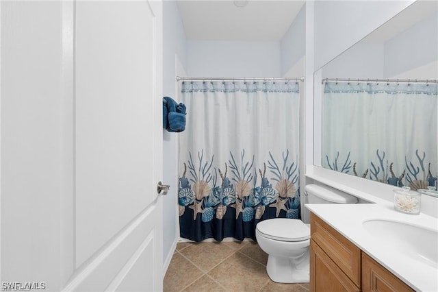 bathroom featuring a shower with curtain, vanity, toilet, and tile patterned flooring