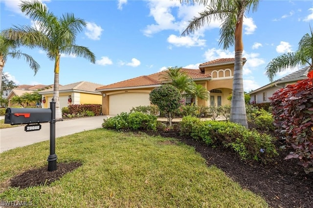 mediterranean / spanish-style house featuring a front lawn and a garage