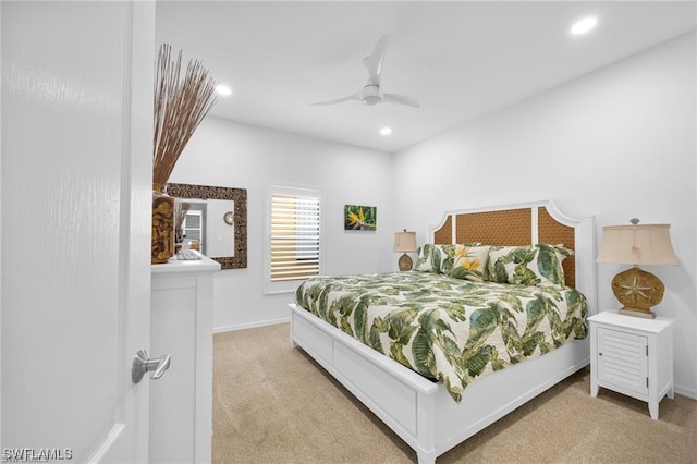 bedroom with ceiling fan and light carpet