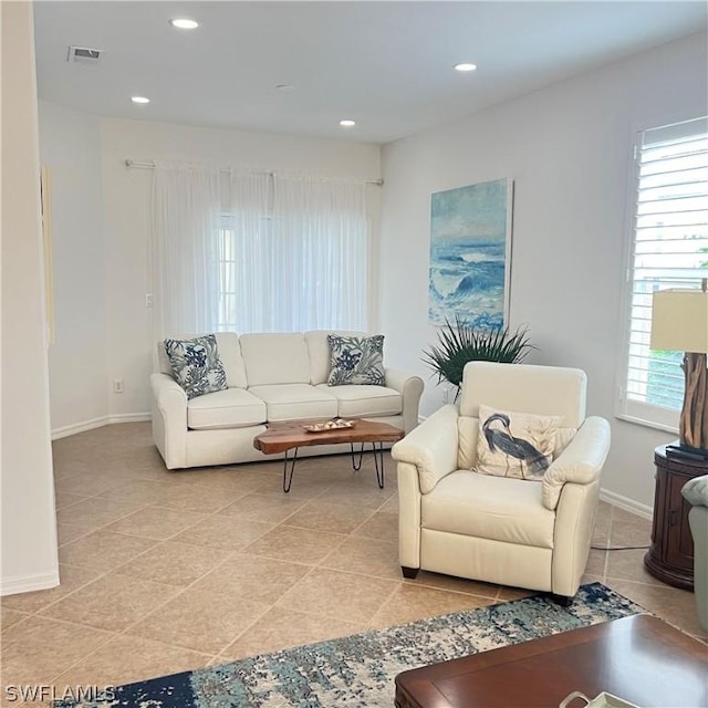 living room with a healthy amount of sunlight and light tile patterned floors