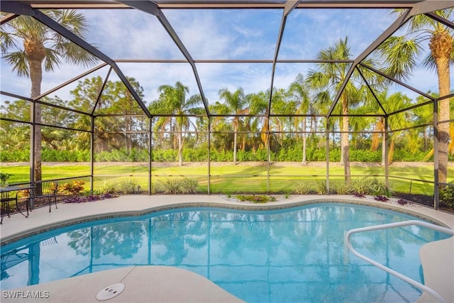 view of pool with a patio and glass enclosure