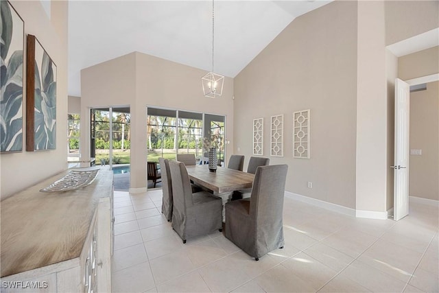 dining area with a notable chandelier, light tile patterned floors, and high vaulted ceiling