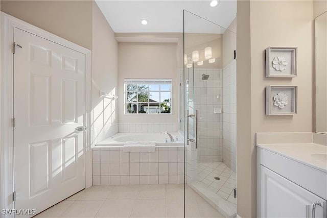 bathroom featuring tile patterned flooring, vanity, and shower with separate bathtub