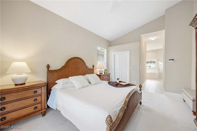 carpeted bedroom featuring lofted ceiling, connected bathroom, and a closet