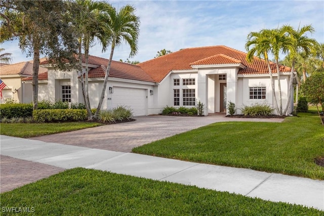 mediterranean / spanish-style home with a garage and a front yard