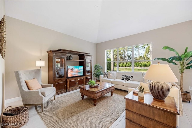 living room with light tile patterned floors and high vaulted ceiling