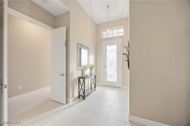 foyer featuring light tile patterned flooring and a healthy amount of sunlight