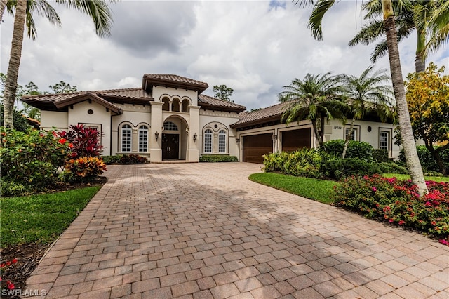 mediterranean / spanish home featuring a garage and french doors