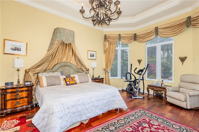 bedroom featuring hardwood / wood-style flooring, a notable chandelier, a raised ceiling, and ornamental molding