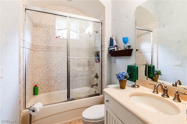 full bathroom featuring vanity, toilet, and bath / shower combo with glass door