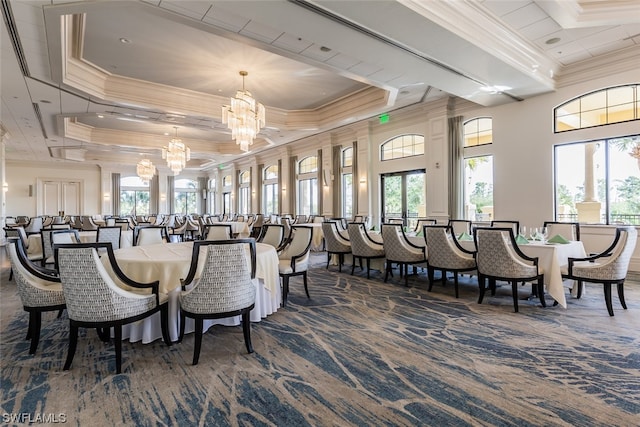 carpeted dining area with a chandelier, a tray ceiling, plenty of natural light, and ornamental molding