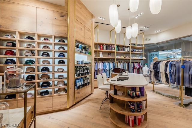 walk in closet with light hardwood / wood-style flooring