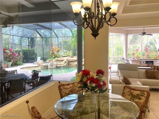 sunroom featuring ceiling fan with notable chandelier