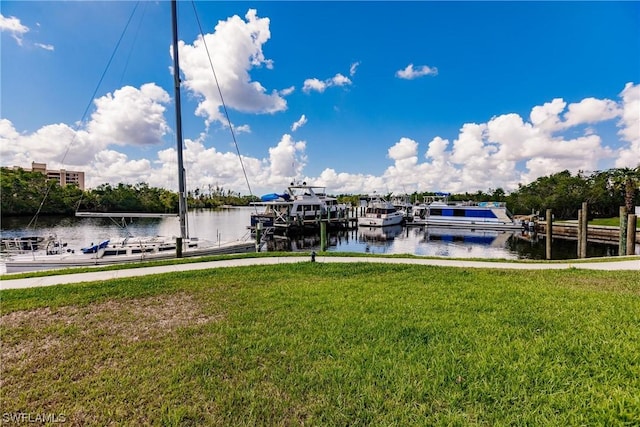 view of dock featuring a yard and a water view