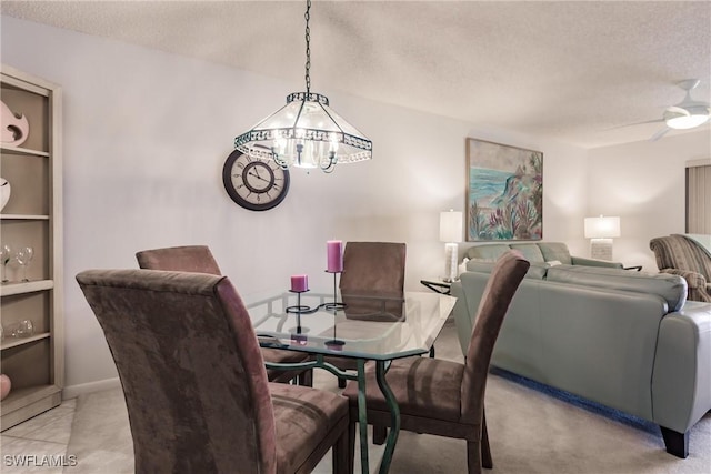 dining room featuring a ceiling fan and a textured ceiling