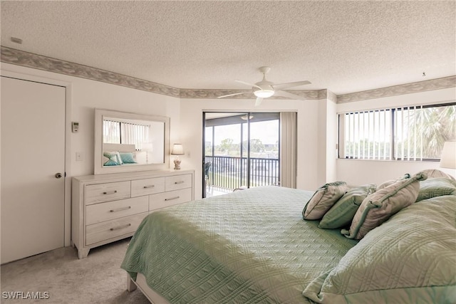 bedroom featuring light carpet, access to outside, a textured ceiling, and ceiling fan