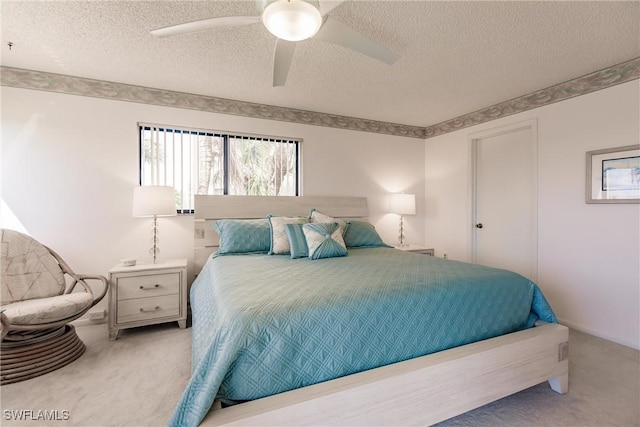 carpeted bedroom with a textured ceiling and ceiling fan