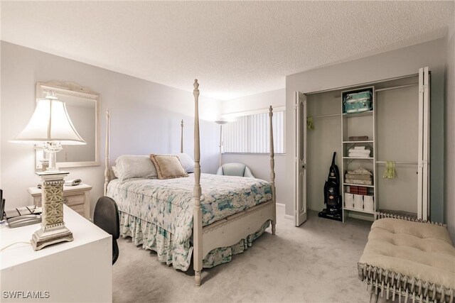 bedroom featuring a closet, a textured ceiling, and light colored carpet