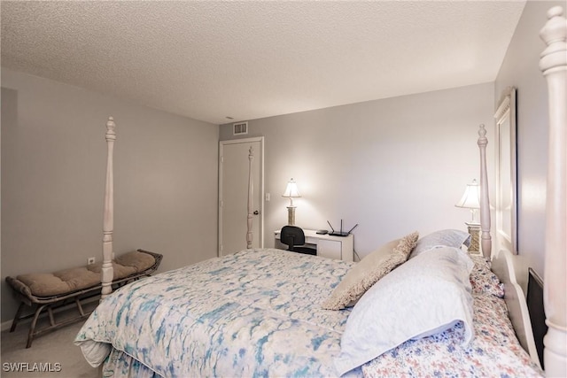 carpeted bedroom featuring a textured ceiling and visible vents