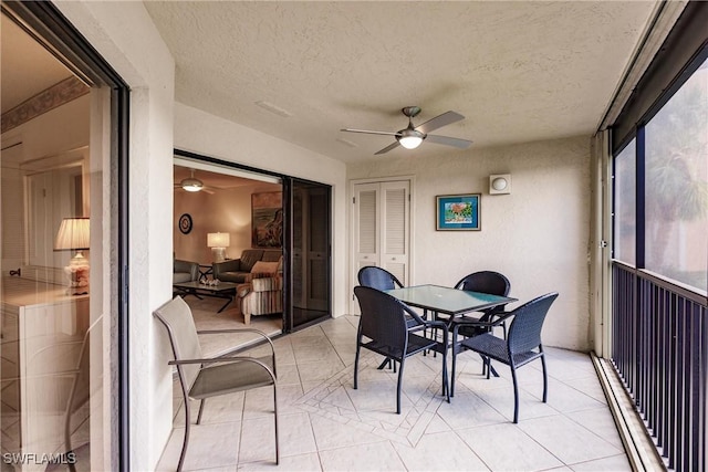 sunroom featuring ceiling fan