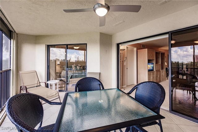 sunroom / solarium featuring ceiling fan