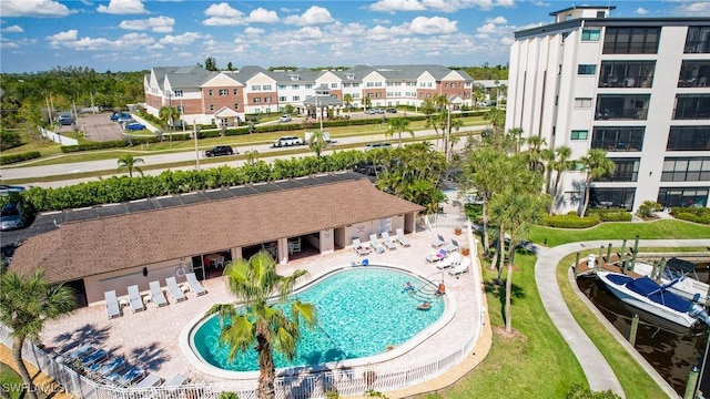 pool featuring a patio area and a residential view