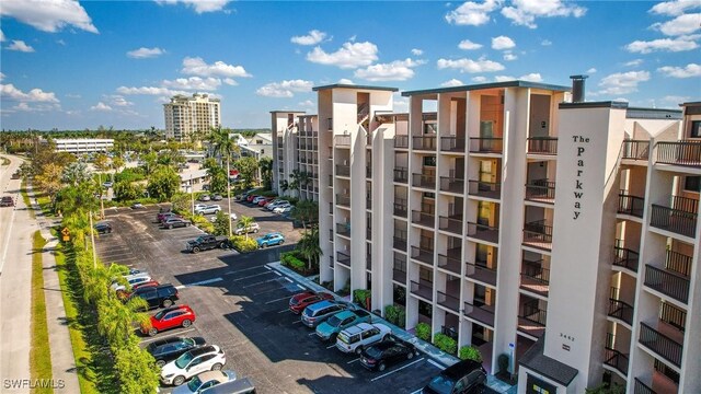 view of building exterior with a view of city and uncovered parking