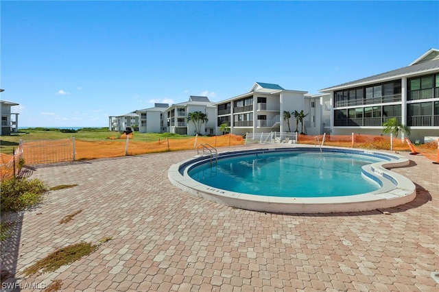 view of pool featuring a sunroom and a patio area