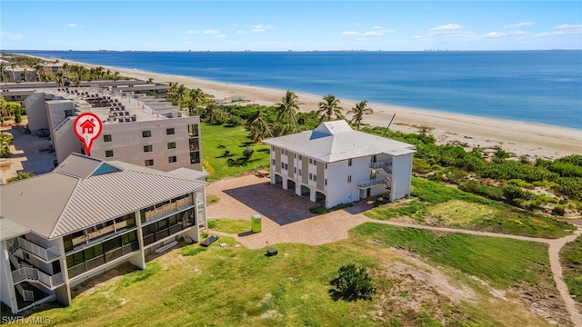 birds eye view of property featuring a view of the beach and a water view