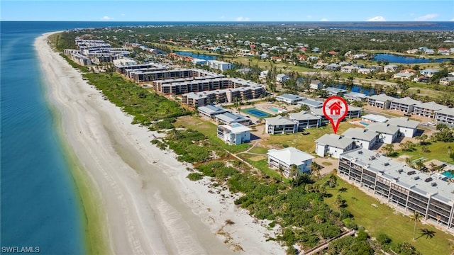 bird's eye view featuring a water view and a beach view