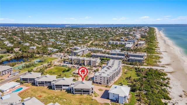 birds eye view of property featuring a beach view and a water view