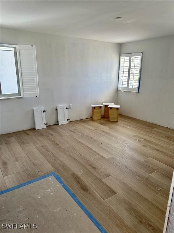 unfurnished room with light wood-type flooring