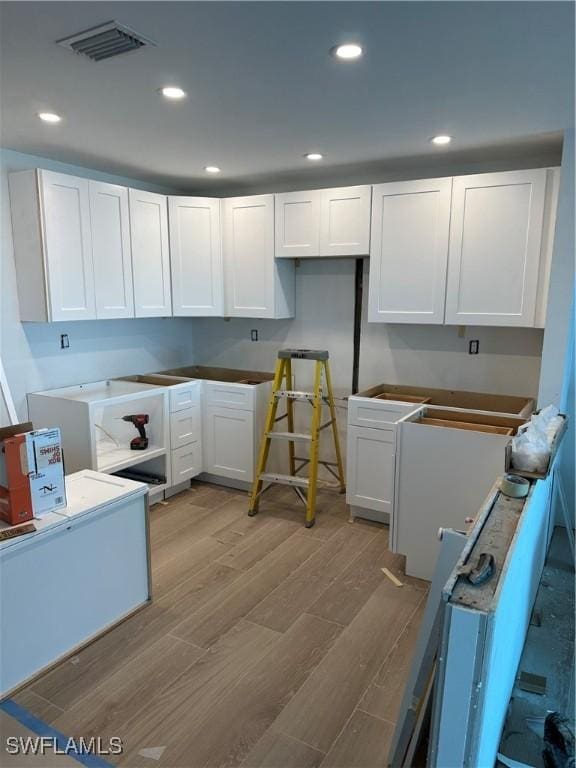 kitchen with recessed lighting, visible vents, white cabinets, and light wood-type flooring