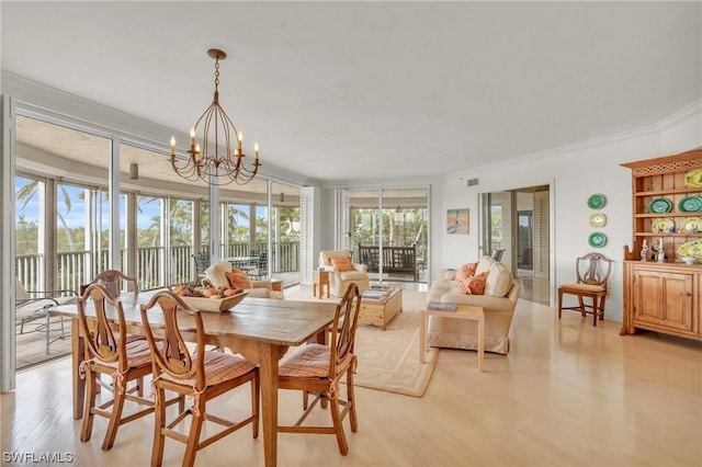 dining room featuring a wall of windows, an inviting chandelier, a wealth of natural light, and crown molding