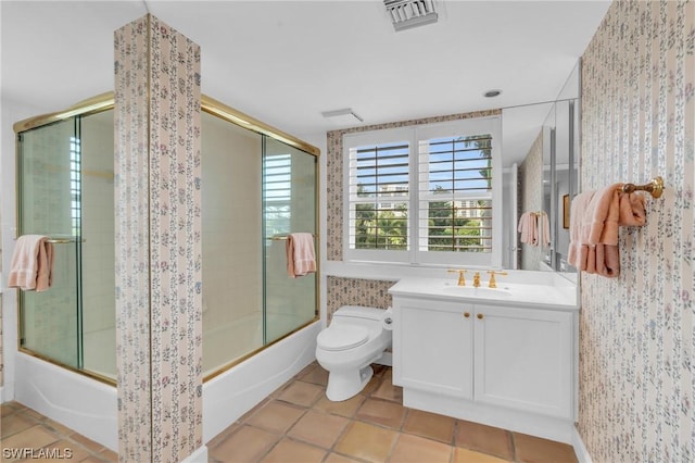 full bathroom with toilet, vanity, tile patterned floors, and combined bath / shower with glass door