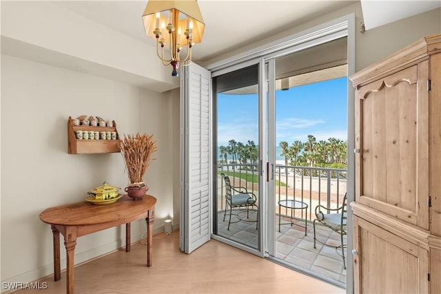 entryway featuring a chandelier and light hardwood / wood-style flooring