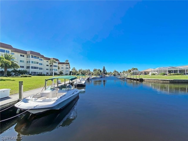 view of dock featuring a water view and a lawn