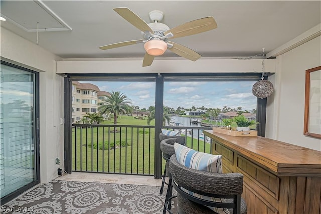 sunroom / solarium featuring a water view