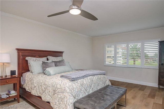 bedroom featuring ornamental molding, hardwood / wood-style flooring, and ceiling fan