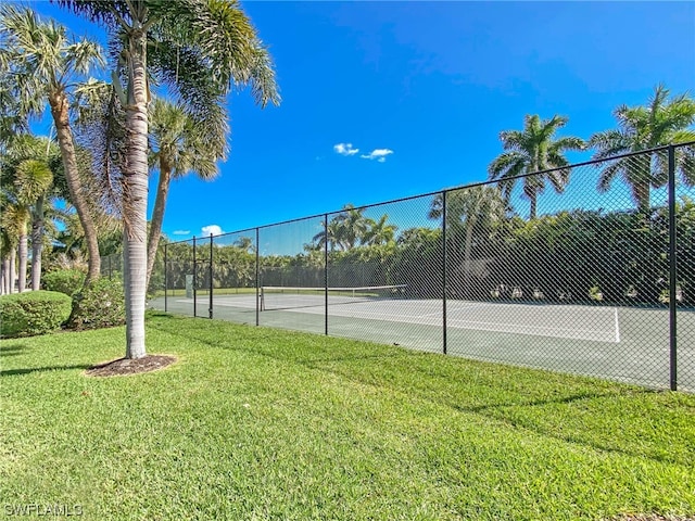 view of sport court featuring a yard