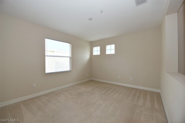 spare room with light colored carpet