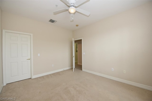 unfurnished bedroom with light colored carpet and ceiling fan